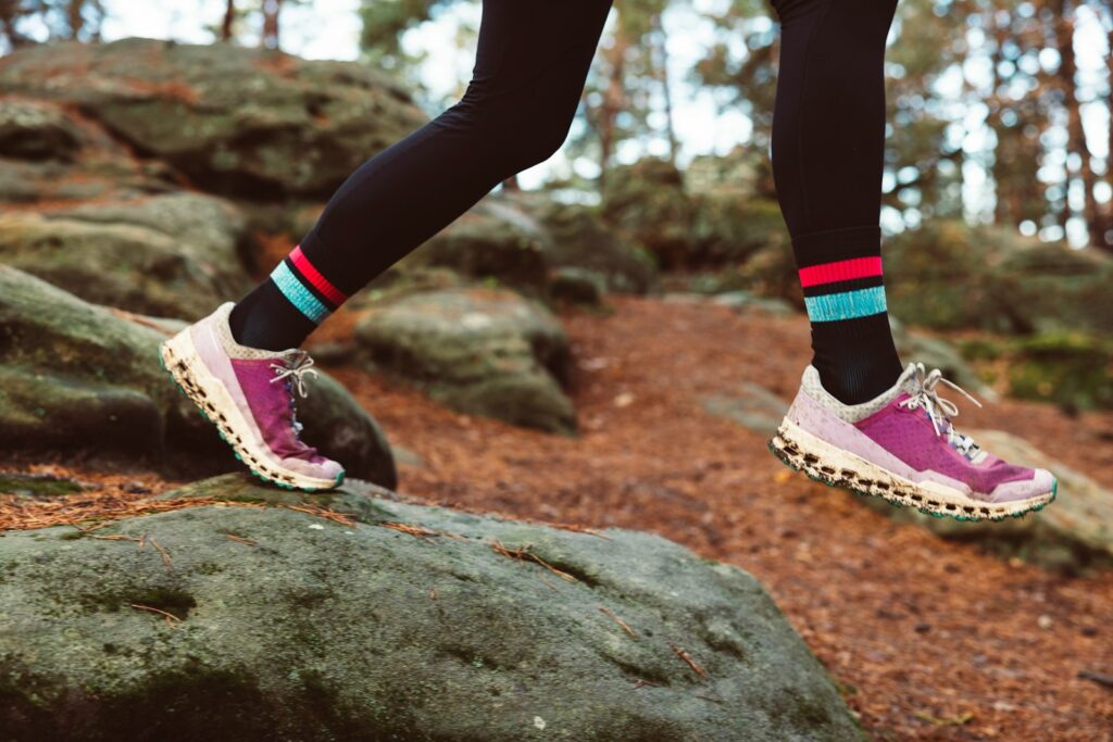 a person walking on a rock in the woods